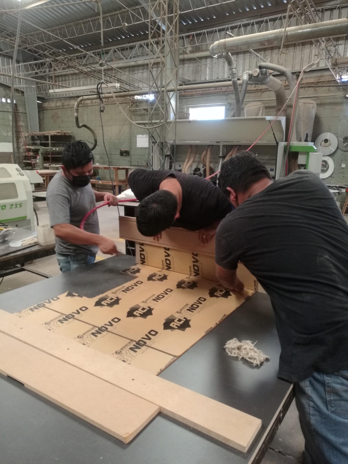 Equipo de producción ensamblando paneles a escala industrial